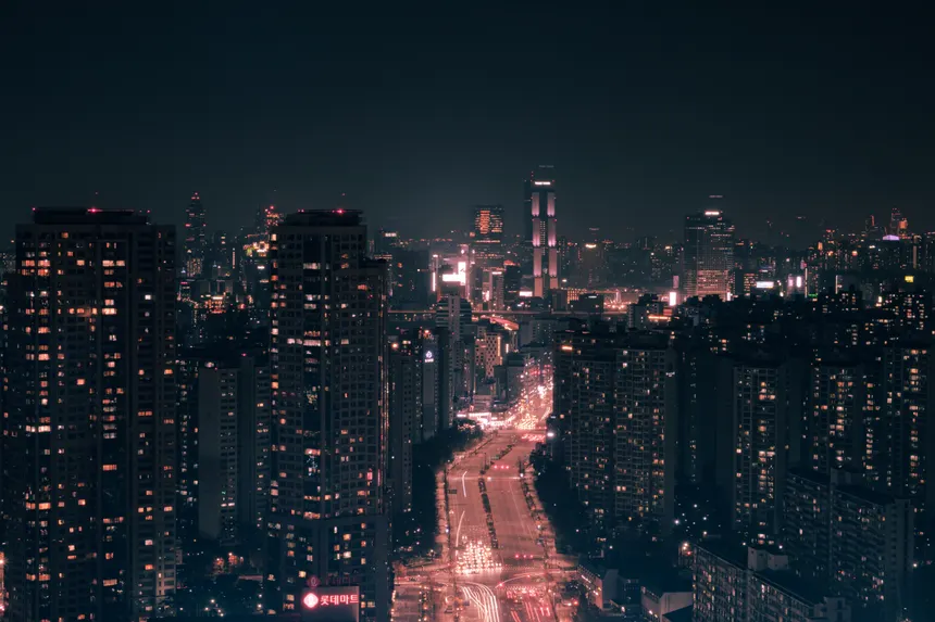 Captivating urban cityscape showcasing illuminated skyscrapers against a night sky.