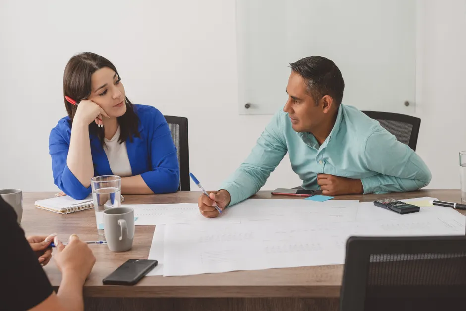 Business professionals engaging in a productive meeting at a modern office workspace.