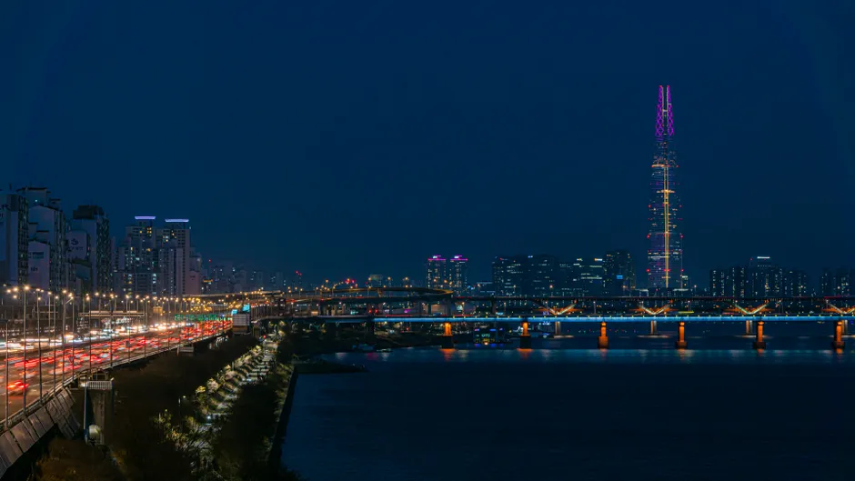 Stunning nighttime view of Seoul cityscape with Lotte Tower and Han River.