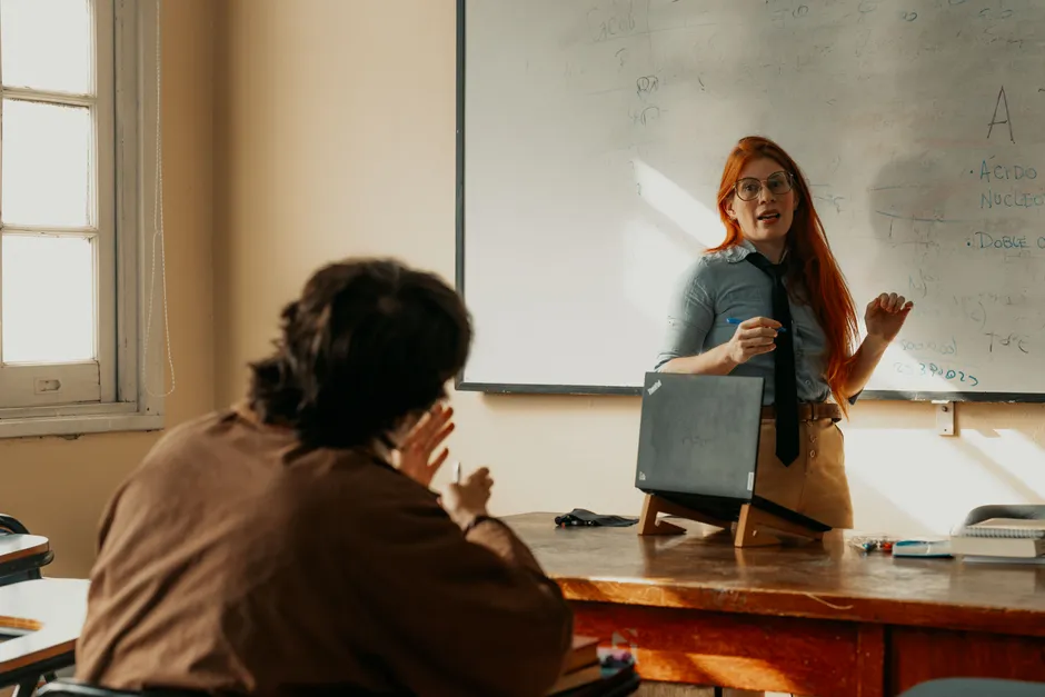 Teacher engages with student during a lesson at a Buenos Aires university classroom.